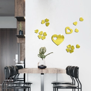 Close-up of golden mirror 3D heart and clover acrylic wall stickers in a modern living room