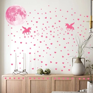 Detail of pink moon and flying unicorn wall stickers in a cozy bedroom nursery decor