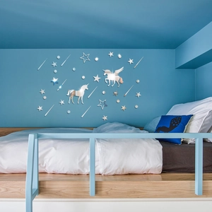 Detailed mirror effect of unicorn and star acrylic wall stickers on a bedroom wall
