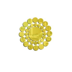 Detail of golden circular mirror wall stickers arranged in a modern sunburst pattern decor