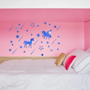Detailed view of dark blue mirror unicorn and stars acrylic wall stickers on a pink wall