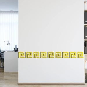 Detail of golden mirror Greek key acrylic wall border stickers on a modern white background