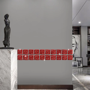 Detail of red acrylic greek key wall border with 3D mirror effect on grey interior wall