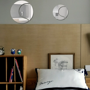 Close-up of decorative acrylic wall mirror with elegant S-shaped streamline curve design