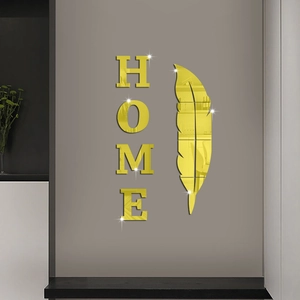 Detailed close-up of golden acrylic mirror HOME wall decals with reflective feather accent