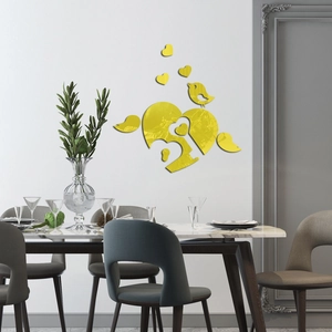 Detail view of yellow mirror heart and bird wall stickers on a dining room wall