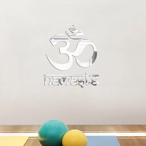 Detailed view of silver mirror acrylic Namaste and Om symbol wall art in yoga setting