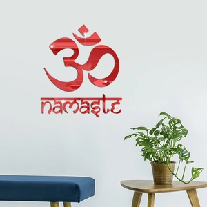 Close-up of red mirror acrylic wall decor with 3D Om symbol and Namaste lettering detail