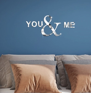 Silver mirror acrylic wall sticker featuring 'YOU & ME' text on blue bedroom wall