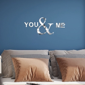 Silver mirror acrylic wall sticker featuring YOU & ME letters on bedroom wall surface