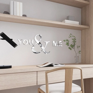 Detail of silver acrylic mirror wall stickers with You & Me text in a modern home office setting