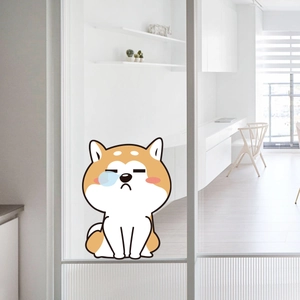Detail view of a cute cartoon Shiba Inu wall sticker on a glass door in a modern room