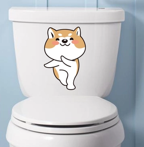 Funny Shiba Inu puppy sticker decoration applied on a white ceramic toilet tank cover