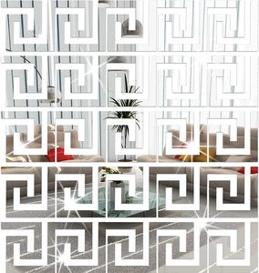 Detailed view of silver meander pattern mirror wall stickers on a living room wall