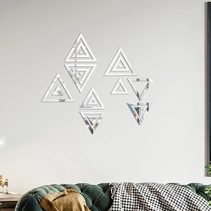Close-up of geometric triangle mirror wall stickers in a modern silver acrylic finish
