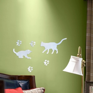 Detail view of mirror cat wall stickers set on wall with silver acrylic paws and cats