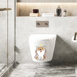 Close-up of a cute cartoon Shiba Inu toilet sticker applied on a white wall-hung toilet