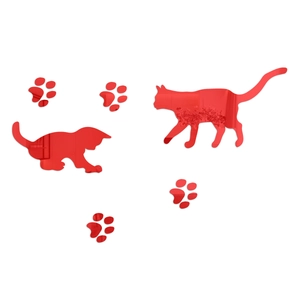 Close-up of shiny red acrylic cat mirror wall stickers with paw prints for home decor