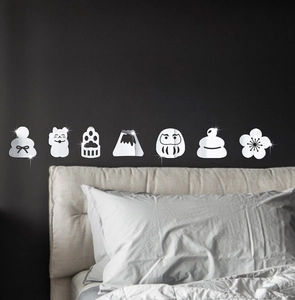 Close-up of Japanese Lucky Cat and Fuji mirror wall stickers on a dark bedroom wall