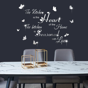 Macro detail of silver acrylic mirror wall stickers with kitchen quotes and 3D butterflies