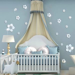 Detail view of 3D acrylic mirror flower wall stickers in a cozy blue nursery setting