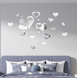 Macro view of mirror heart wall stickers set in a modern bedroom interior design
