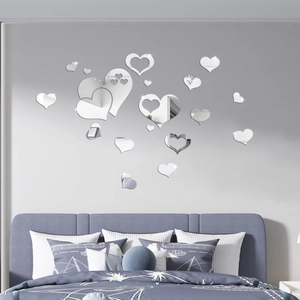 Detail of silver heart-shaped mirror wall stickers in various sizes for bedroom decoration