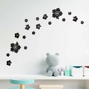 Detailed close-up of 3D black acrylic floral wall stickers with a reflective mirror finish
