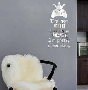 Close-up of silver mirror game wall sticker featuring a crown and game controller icon