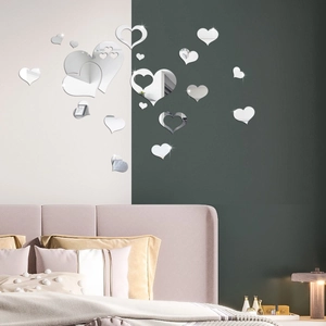 Detailed view of 3D mirror heart wall stickers in varied sizes on a modern bedroom wall