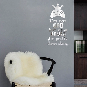 Close-up of silver mirror gamer wall sticker with game controller and crown motif