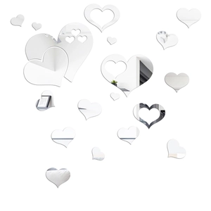 Macro detail of 3D heart-shaped mirror wall stickers with reflective silver finish