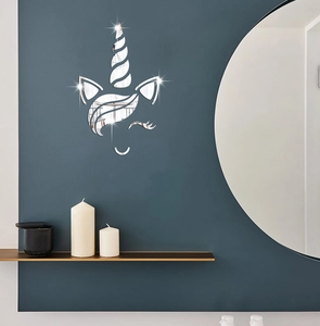 Detailed close-up of unicorn acrylic mirror wall stickers on a dark blue wall in a child room