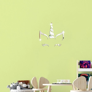 Close-up of unicorn acrylic mirror wall decals in a cozy kids room with green wall