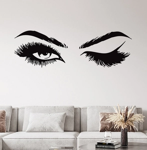 Detail of minimalist creative eyelashes wall decal in a modern living room setting