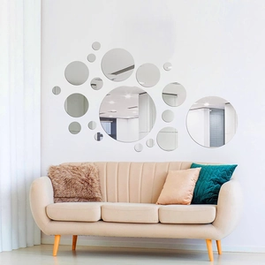 Artistic arrangement of round acrylic mirror wall stickers on a minimalist living room wall