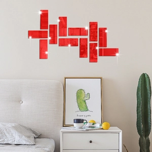 Detail of red acrylic mirror wall stickers showing reflective finish in a modern bedroom