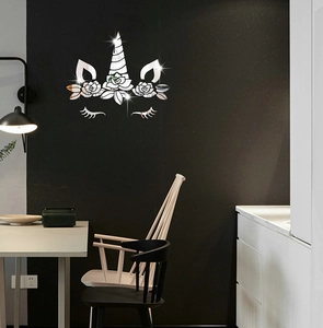 Detail of silver unicorn mirror wall stickers featuring floral accents on a black wall