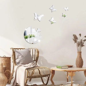 Detail of 3D mirror butterfly wall stickers above a cozy chair in a warm room setting