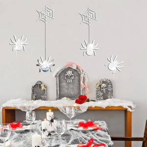 Halloween silver acrylic mirror spider and web wall stickers on a grey festive party wall