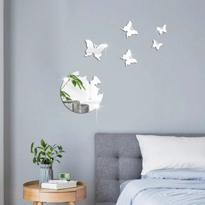 Detail of 3D mirror butterfly wall stickers with silver acrylic reflection on bedroom wall