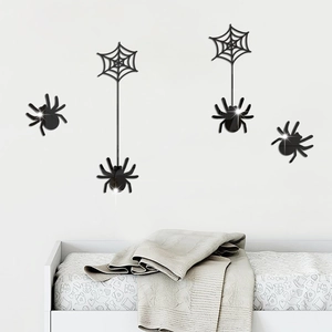 Close-up of black acrylic spider wall stickers with mirror finish for Halloween decoration