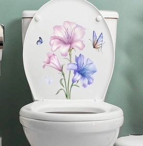 Detailed view of lily flower toilet stickers with blue butterflies on white ceramic lid