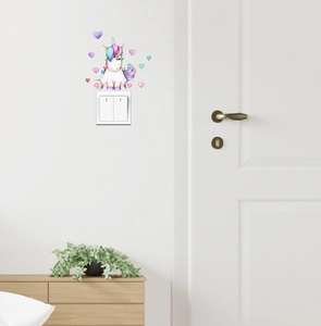 Detail of watercolor unicorn wall sticker and colorful hearts above a light switch