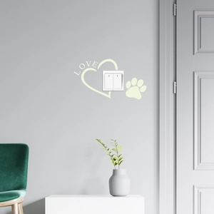 Glow-in-the-dark heart and paw print stickers surrounding a white wall light switch