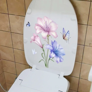 Pink and purple lily flower toilet lid decals with butterfly accents on tiled wall