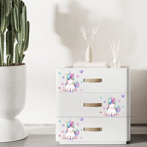 Cute cartoon unicorn wall stickers for kids room decor on white wooden drawers