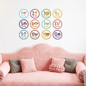 Set of 12 colorful baby monthly milestone wall stickers with cartoon animals for nursery decor