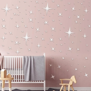 Star-shaped acrylic mirror wall stickers in a cozy pink nursery setting with a baby crib