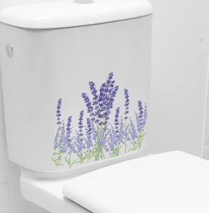 Detail view of purple lavender floral decals applied on a white ceramic toilet tank